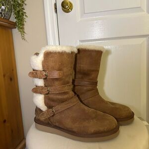 Brown Uggs with fur lining. Buckles and fur on back. Lightly used.